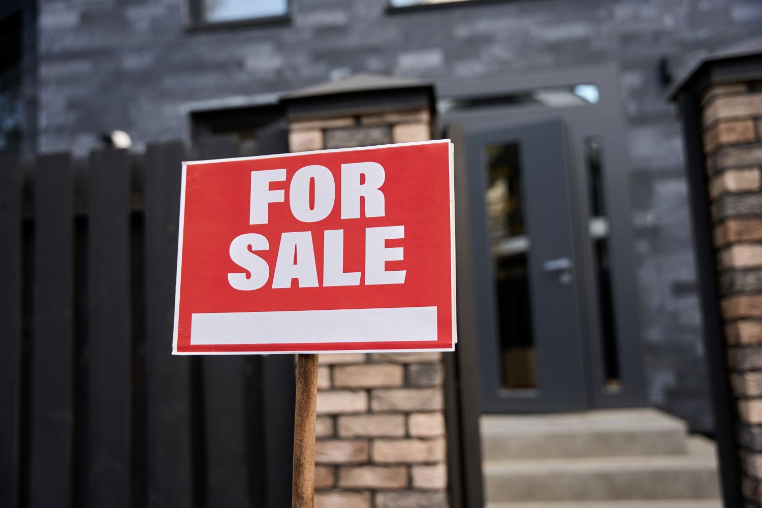 house with a for sale sign in front